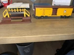 Lionel #3672 Bosco Operating Milk Car,w/platform & 5 Cans, C-8 Light Run. Fixed Price $299.00.